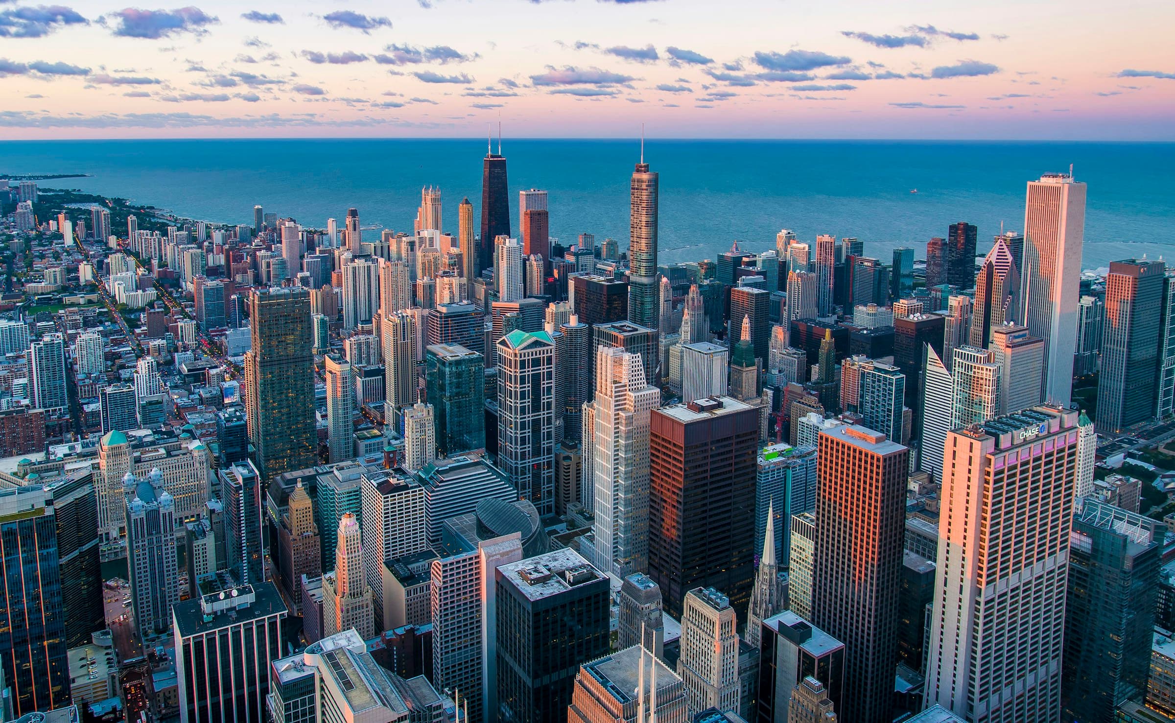 Aerial city at dusk — the systems that run the world